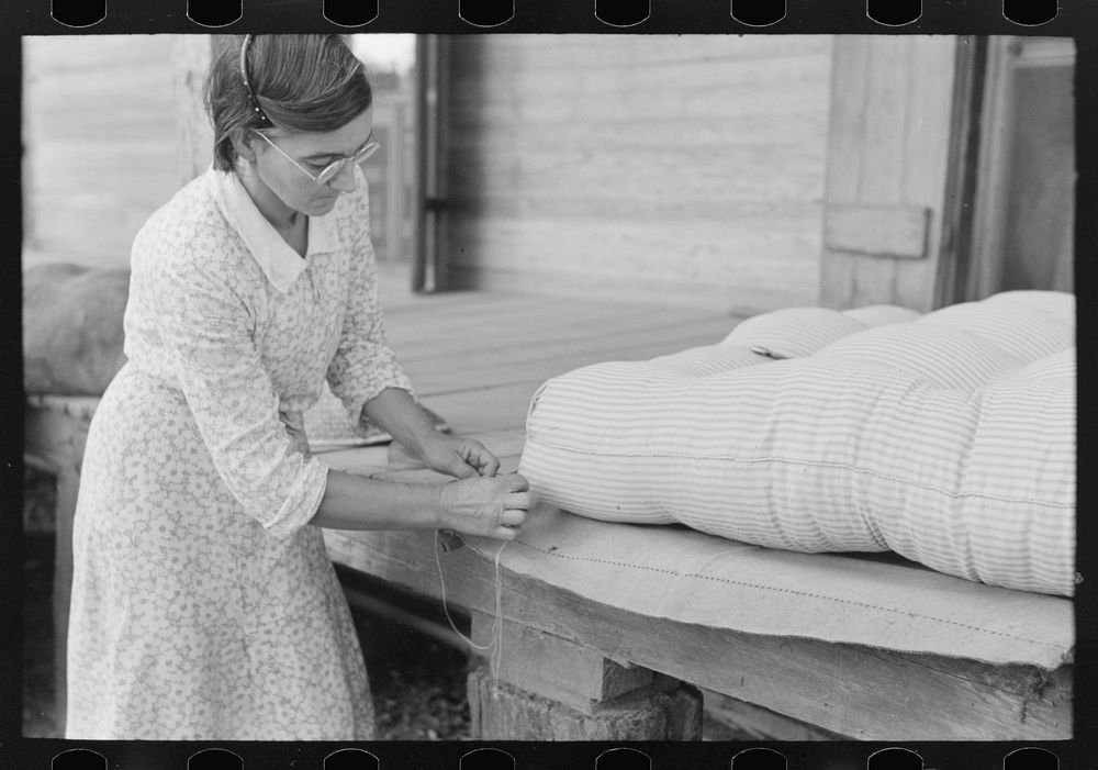 Wife of small cane farmer near Jarreau, Louisiana, making mattress of moss by Russell Lee