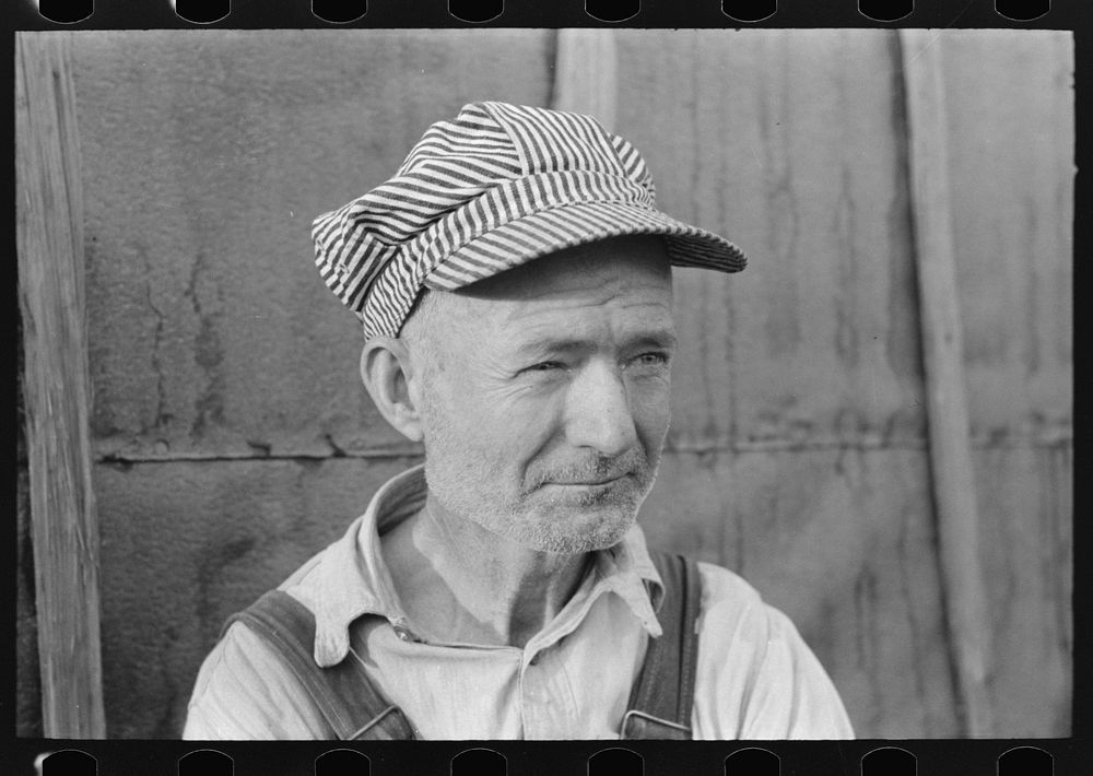 [Untitled photo, possibly related to: Day laborer with sugarcane knife in front of his shack home near New Iberia…