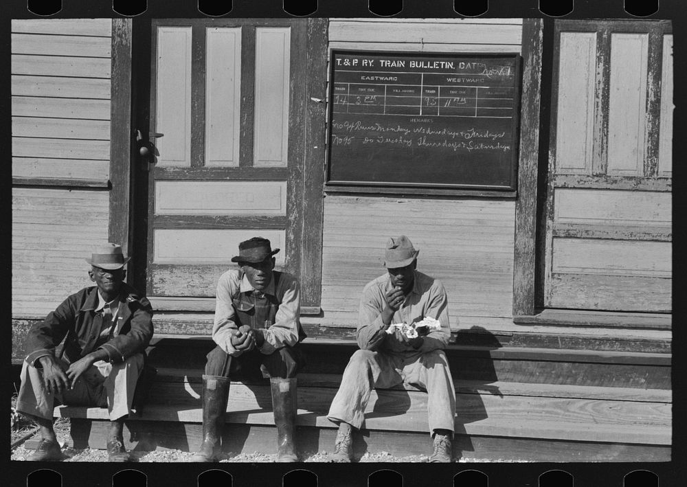 es sitting on foot of the T&P (Texas and Pacific) railroad station, New Roads, Louisiana. Note frequency of train operations…