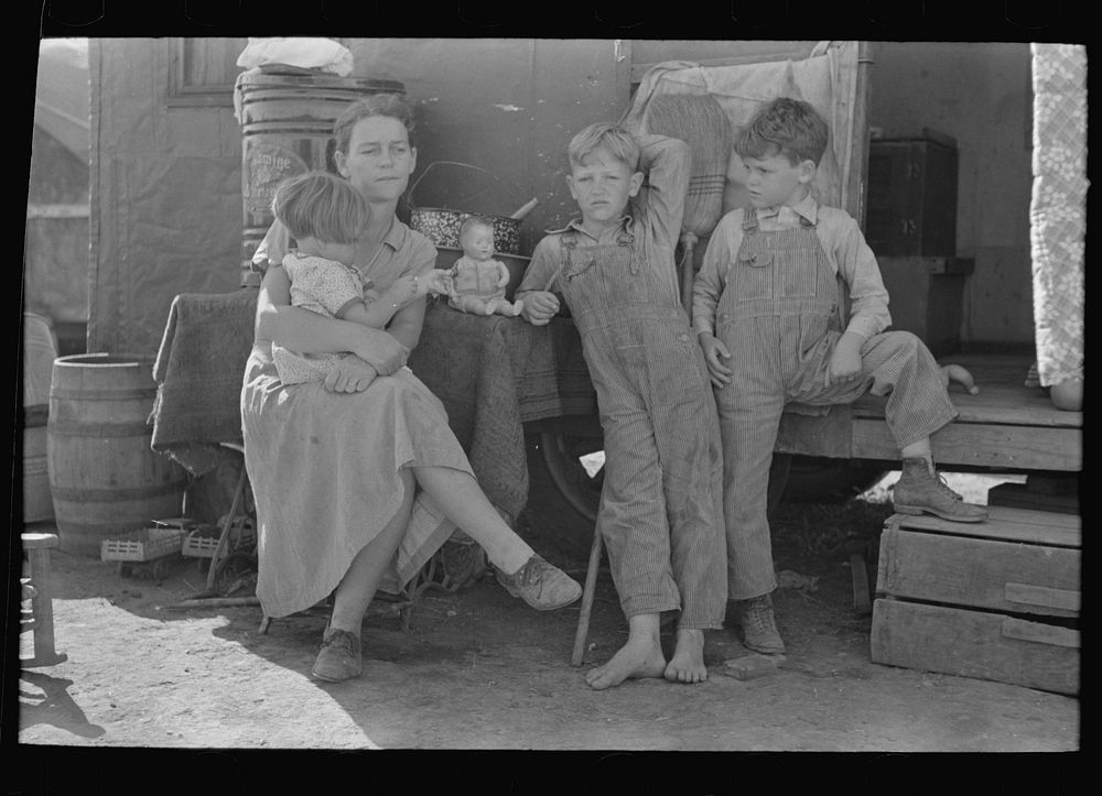 White migrant mother with children in front of trailer home, Weslaco, Texas by Russell Lee
