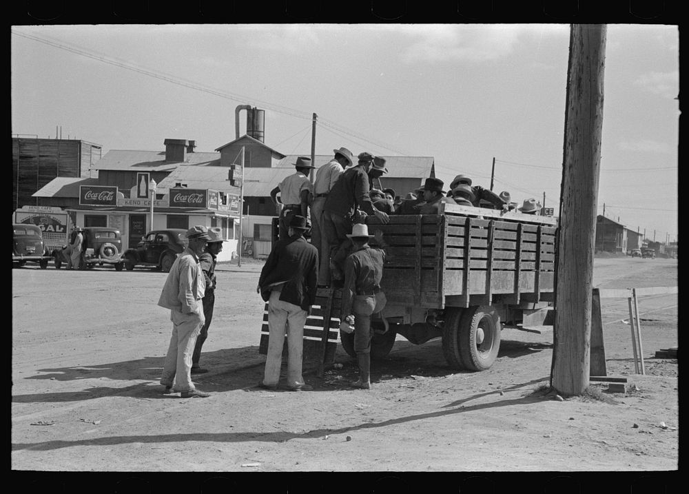 Mexican day laborers being loaded into truck for transportation to field, Weslaco, Texas by Russell Lee