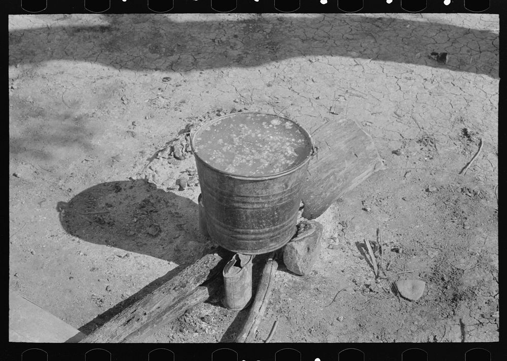 Cooking corn preparatory to making tortillas in front of Mexican hut, near Santa Maria, Texas by Russell Lee