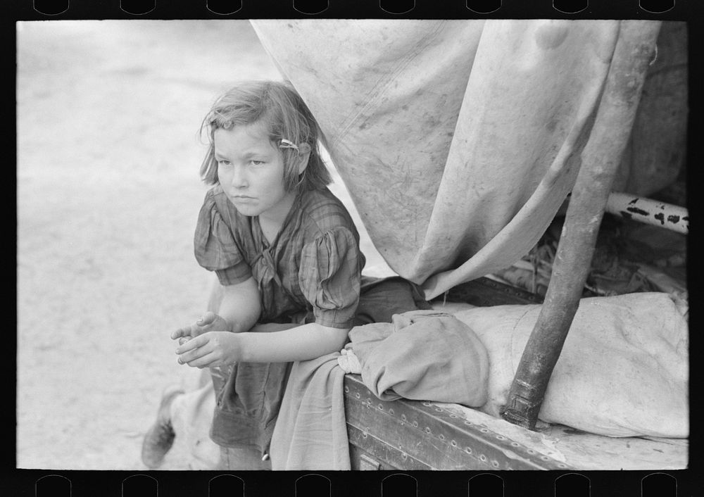 [Untitled photo, possibly related to: A child of  migrant in her playhouse. The rusted scales represented a clock to the…