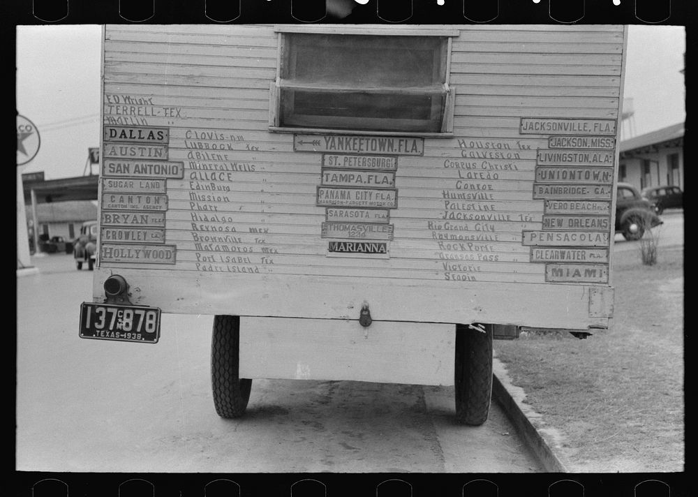Truck home of traveler with plates from cities he has visited. Harlingen, Texas by Russell Lee