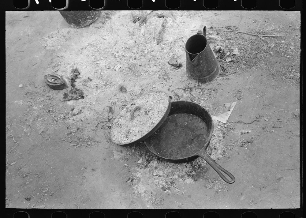 Skillet with skeleton lid and coffee pot in active use by white migrant family from Arizona, near Harlingen, Texas by…