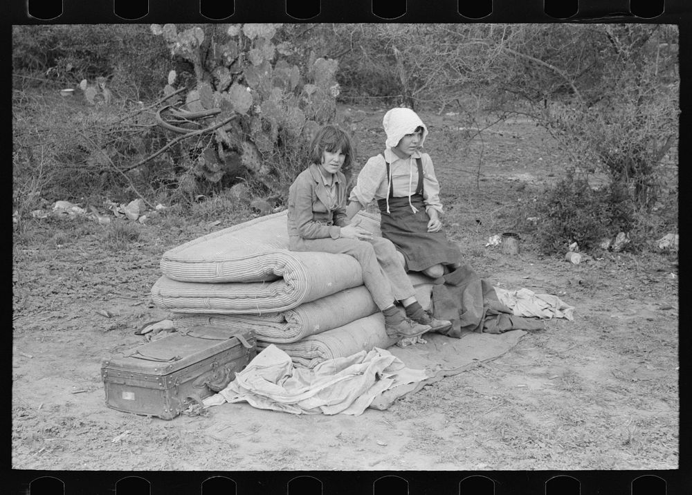 [Untitled photo, possibly related to: Children of white migrants from west Texas sitting on mattresses just unloaded from…