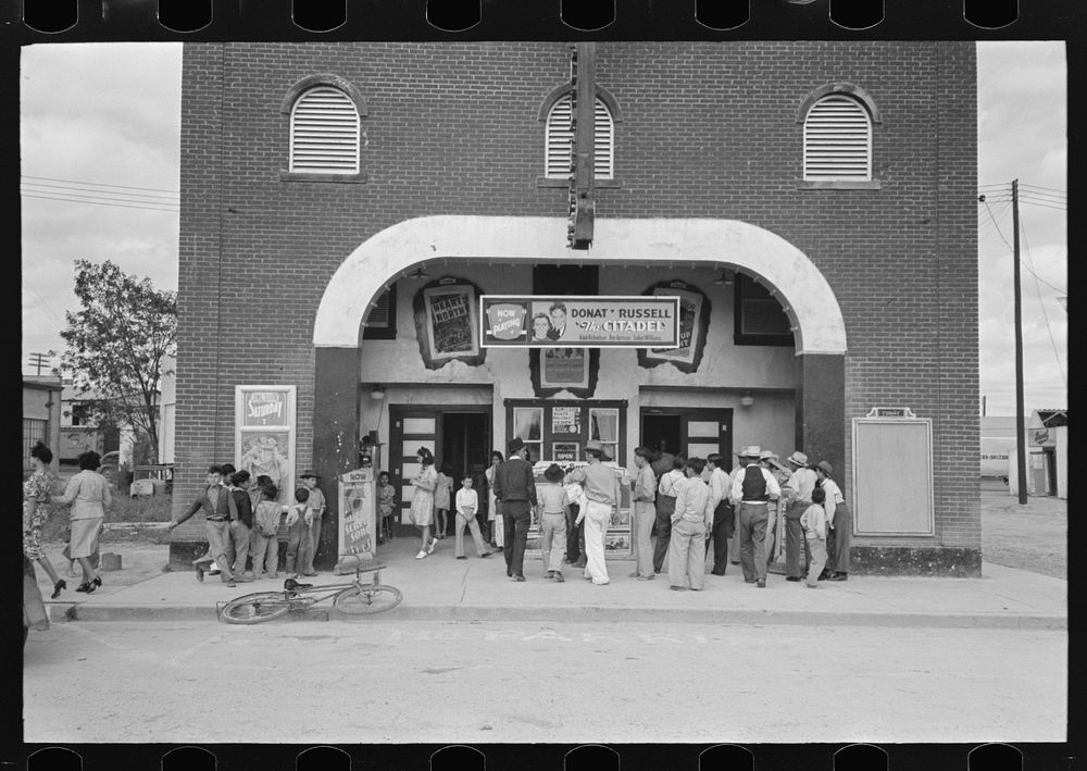Waiting for the movie to open, Sunday afternoon, Pharr, Texas by Russell Lee