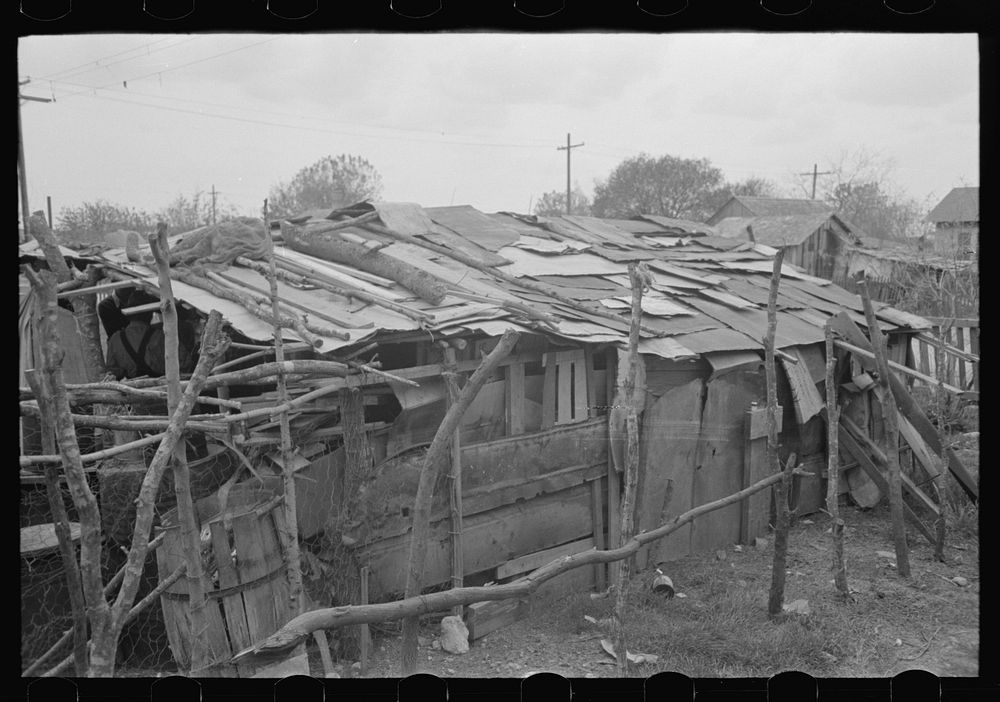 Home of Mexican squatters in San Antonio, Texas. They were receiving commodities from relief by Russell Lee