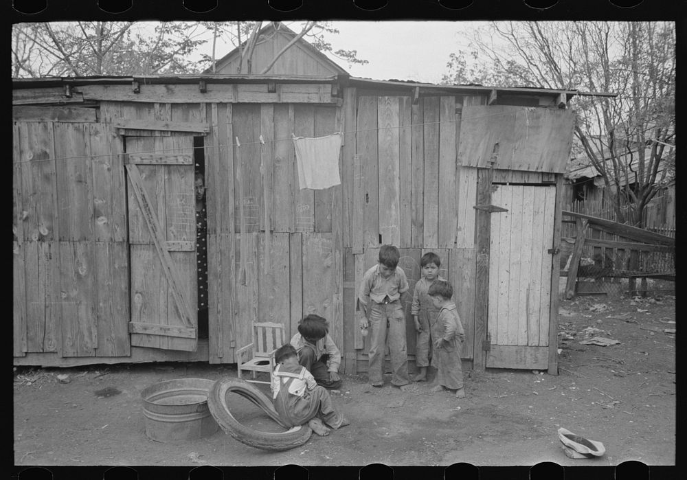 Boys playing in front of backyard house, San Antonio, Texas by Russell Lee