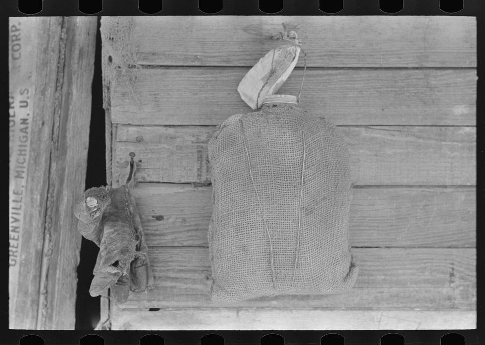 Burlap-covered water bottle in Mexican house, San Antonio, Texas by Russell Lee