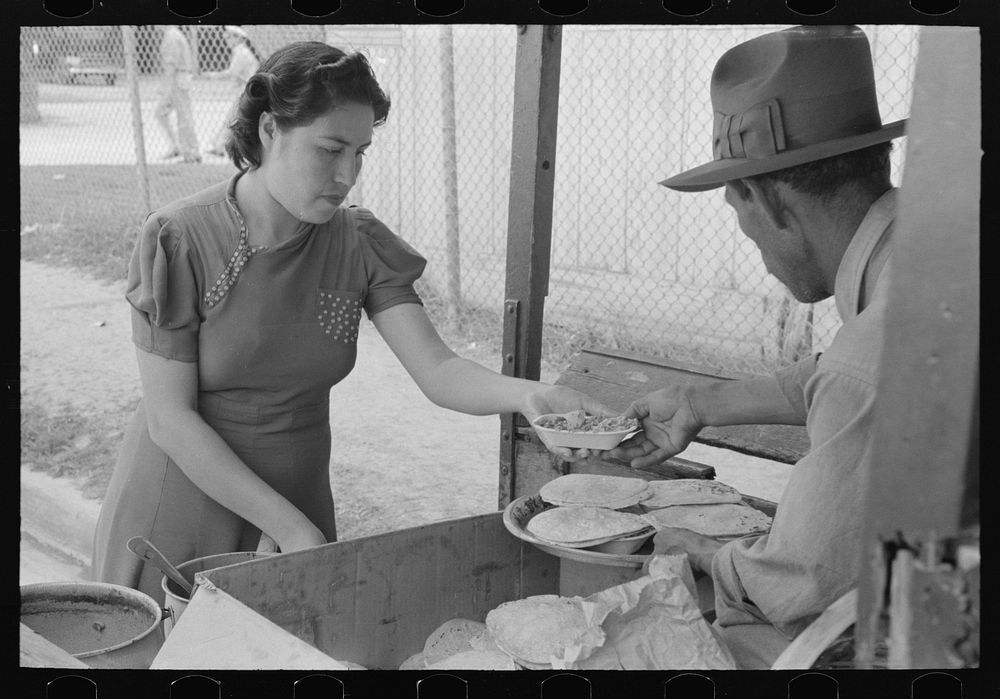 Preparing plates of tortillas and fried beans to sell to pecan shellers, San Antonio, Texas by Russell Lee