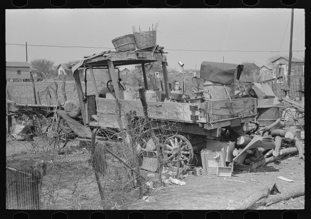 Backyard of Mexican family with old truck, Mexican district, San Antonio, Texas by Russell Lee