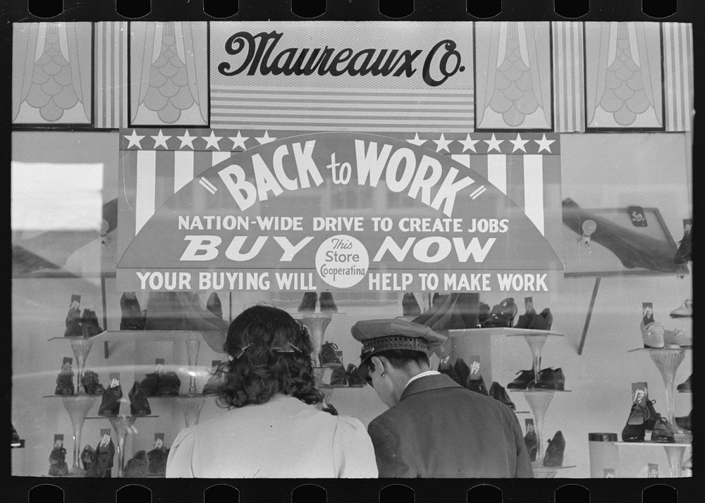 Window shoppers and sign on department store window, Mexican district, San Antonio, Texas by Russell Lee