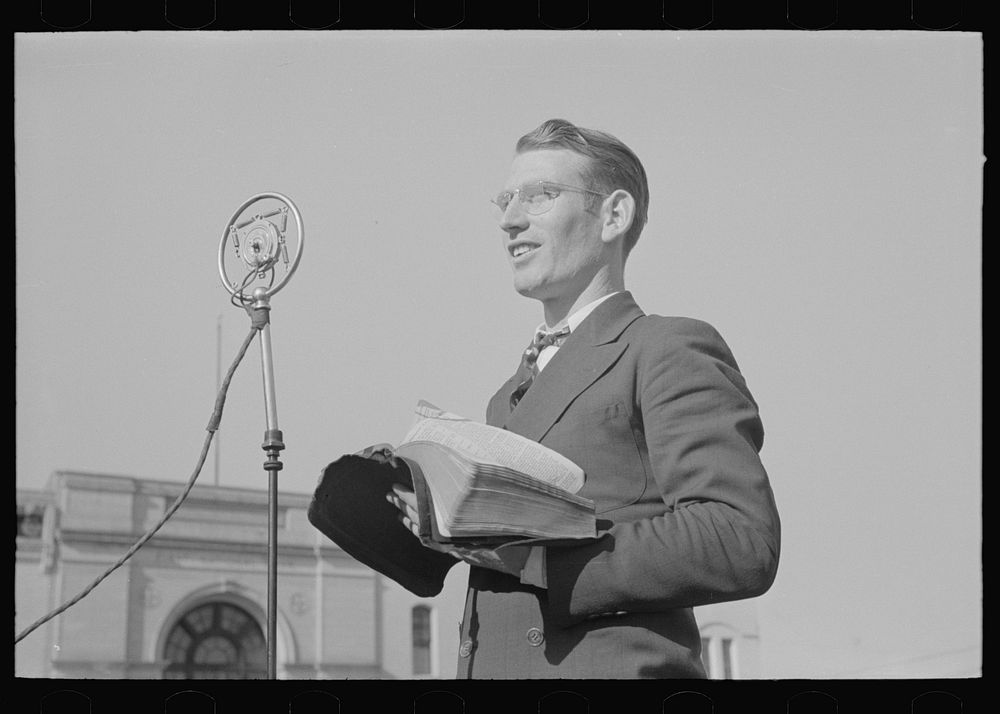 Itinerant preacher broadcasting to his audience by means of public address system on streets of Marshall, Texas by Russell…
