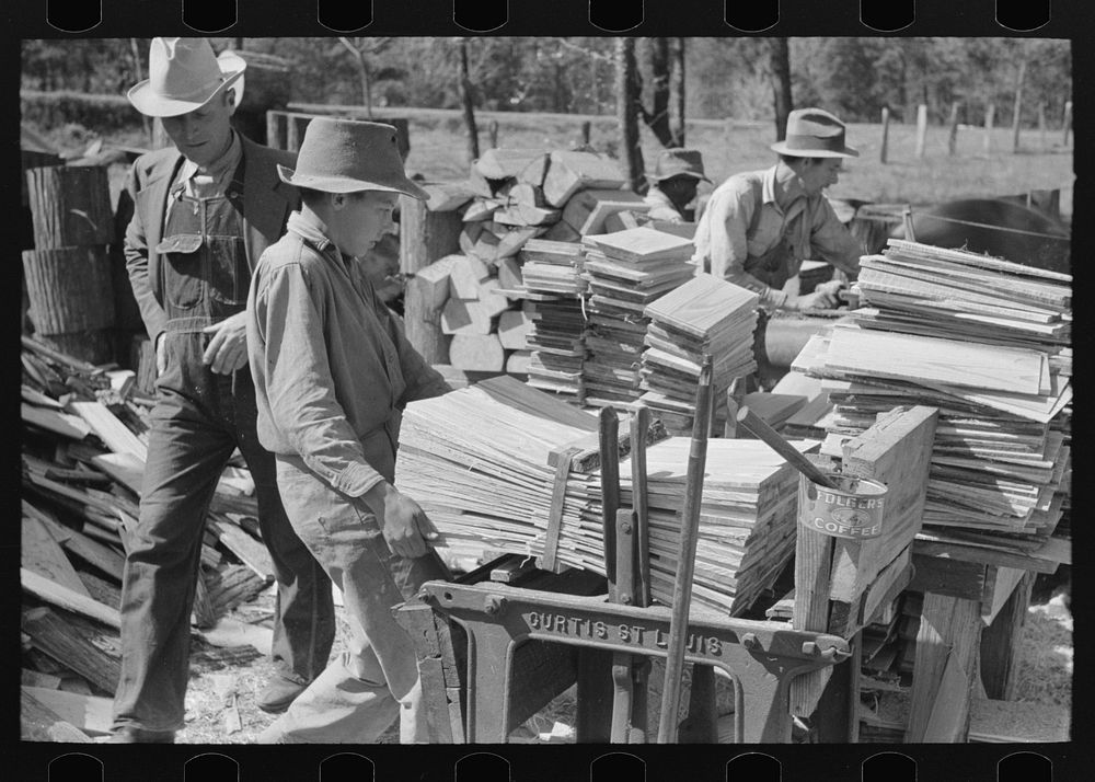 [Untitled photo, possibly related to: Young boy packing shingles at small mill near Jefferson, Texas] by Russell Lee