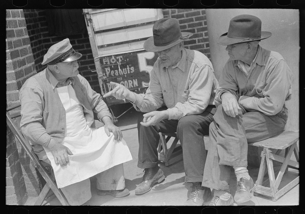 Two farmers talking to popcorn man, San Augustine, Texas by Russell Lee