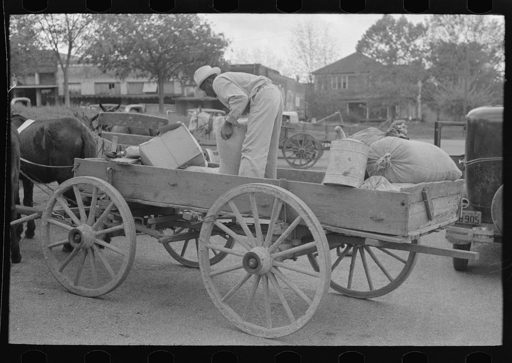  farmer loading supplies into his wagon, Saturday afternoon, San Augustine, Texas by Russell Lee
