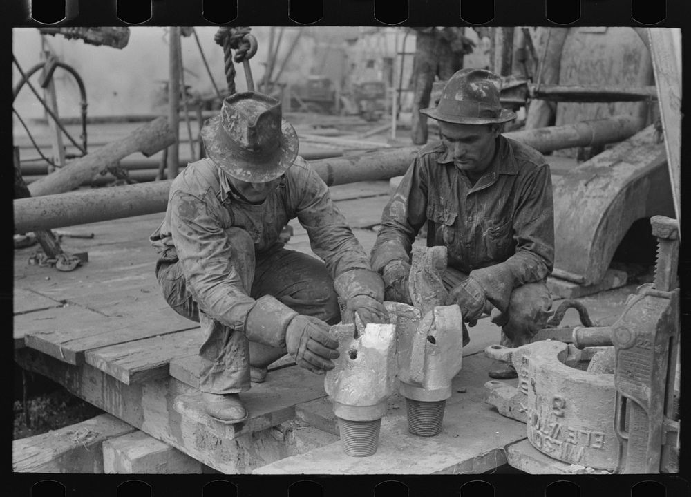[Untitled photo, possibly related to: Oil field workers talking together with bits in front of them, Kilgore, Texas] by…