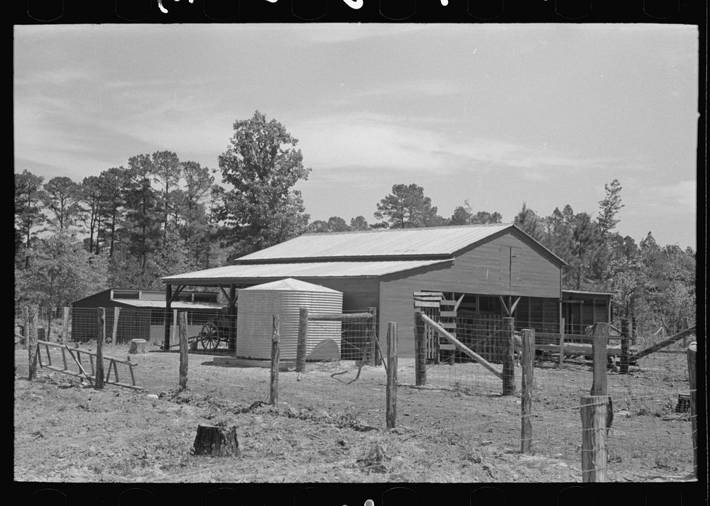 [Untitled photo, possibly related to: Barn and water tank of FSA (Farm Security Administration) client, Sabine Farms…