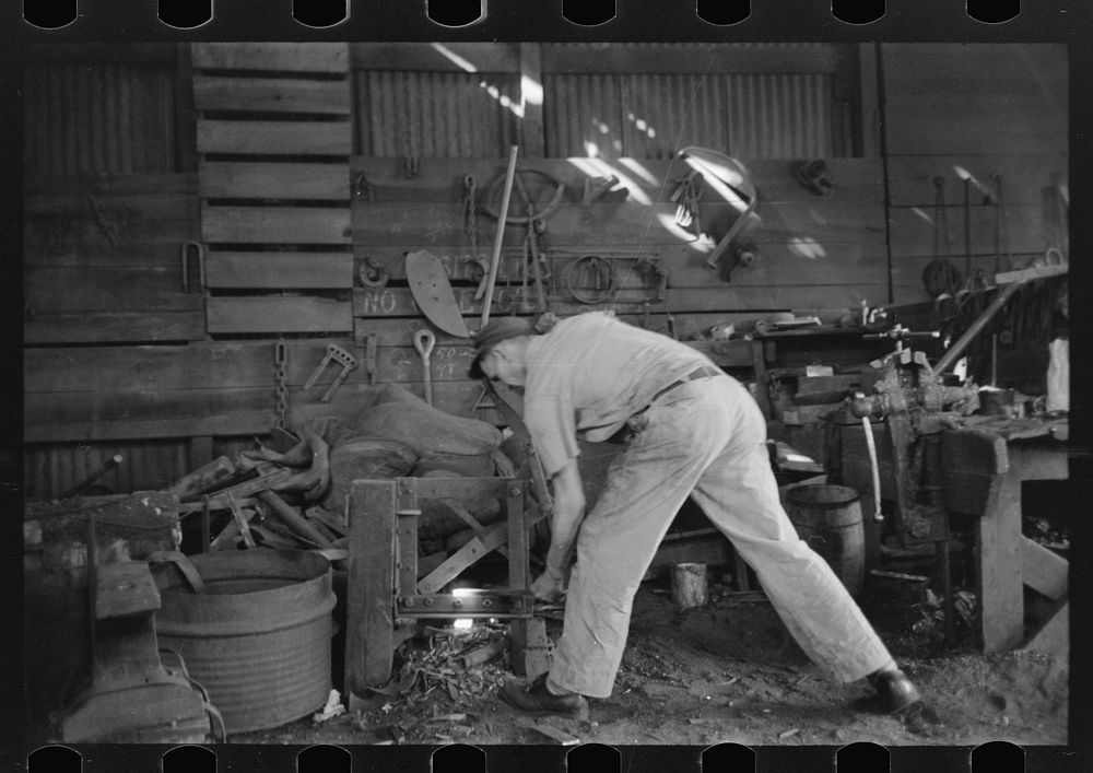 [Untitled photo, possibly related to: Blacksmith at work in his shop, San Augustine, Texas] by Russell Lee