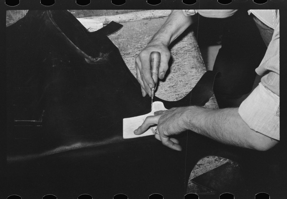 Cutting out heel of the upper from piece of leather. Bootmaking shop, Alpine, Texas by Russell Lee