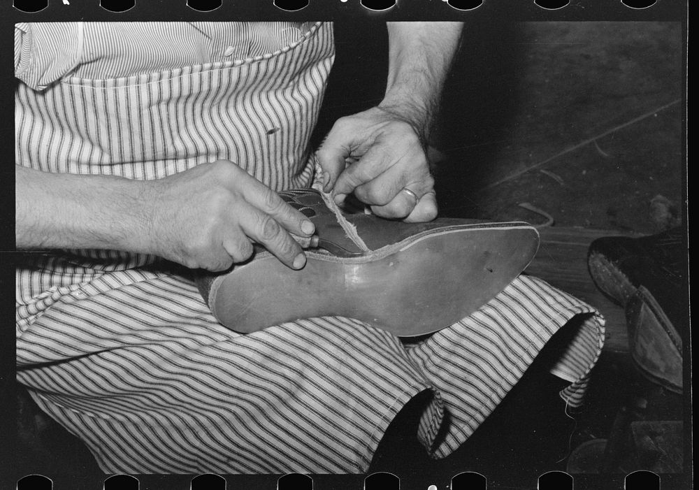 Trimming excess leather from sole. Cowboy bootmaking shop, Alpine, Texas by Russell Lee