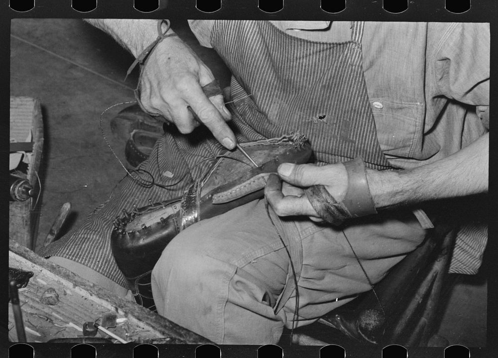 Sewing foot of boot onto sole of Goodyear welt system. Cowboy boot shop, Alpine, Texas by Russell Lee