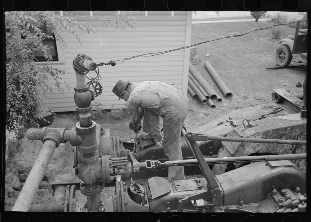 [Untitled photo, possibly related to: Working on steam drilling engine, oil well, Kilgore, Texas] by Russell Lee