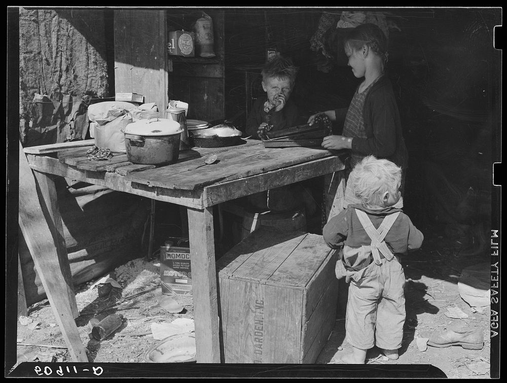 [Untitled photo, possibly related to: Children of migrant packinghouse workers, living in a "lean-to" made of pieces of…