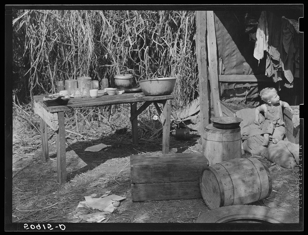 Table for eating and washing outside migrant packinghouse worker's shack. Belle Glade, Florida. Sourced from the Library of…