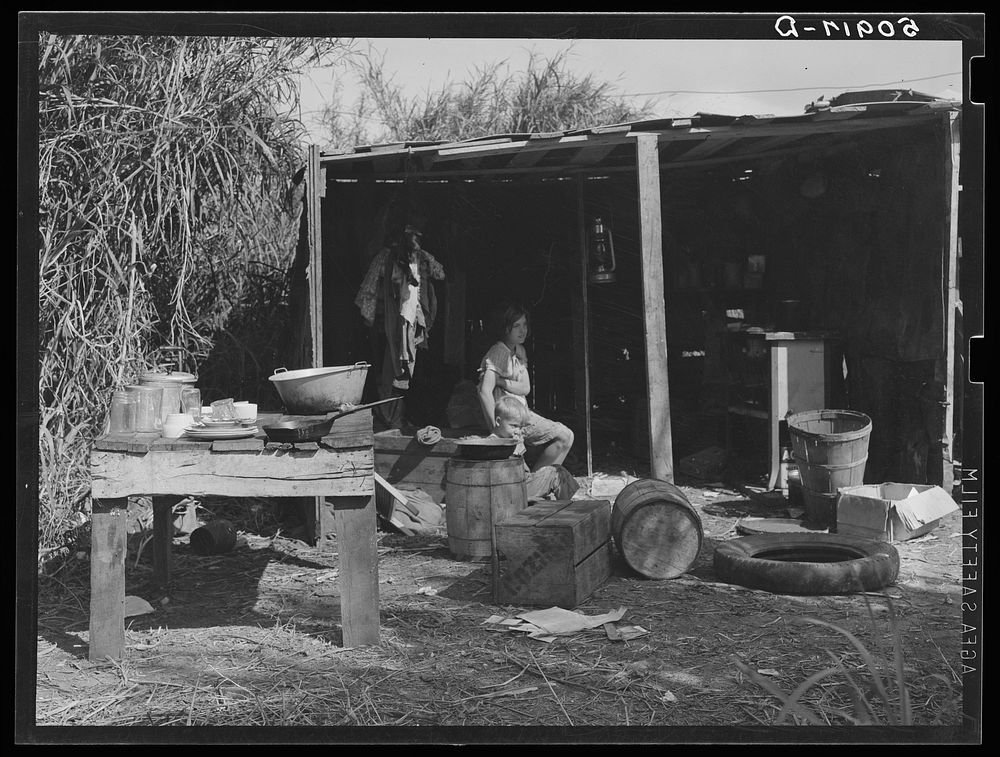 [Untitled photo, possibly related to: Table for eating and washing outside migrant packinghouse worker's shack. Belle Glade…