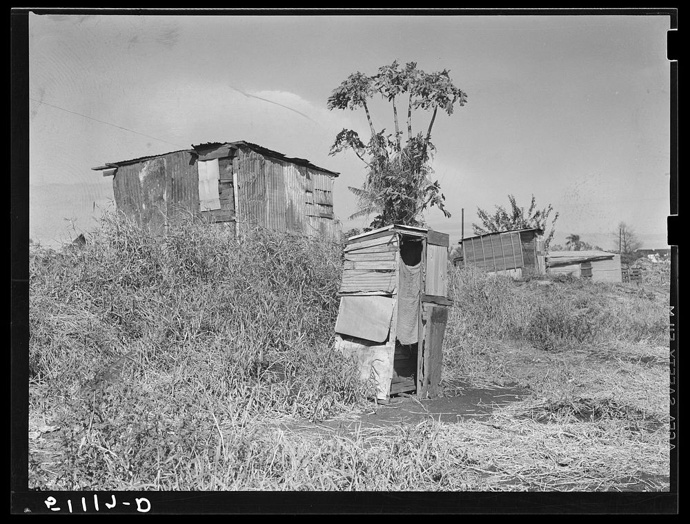 Migrant vegetable pickers and packinghouse workers living quarters off main highway near Lake Harbor, Florida. Sourced from…