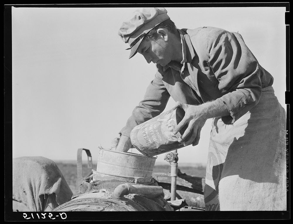 Migrant day laborer from Carolina mixing spray to kill white flies and nourish bean plants through leaves. Near Belle Glade…