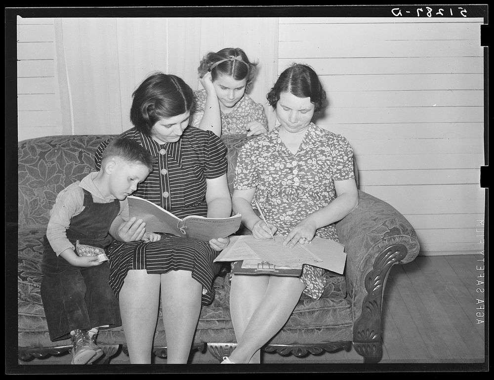 Mrs. Helms going over her record book with home supervisor. Coffee County, Alabama. Sourced from the Library of Congress.