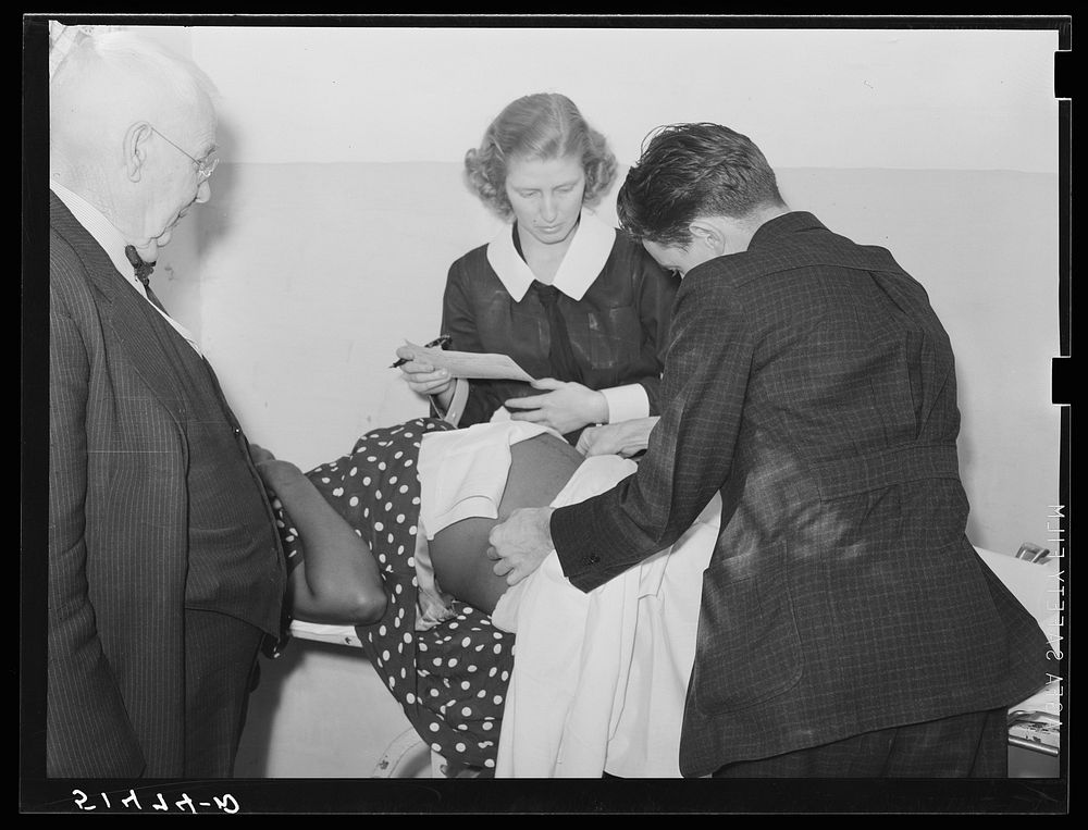 Doctor Lewis and Miss Teal, nurse, measuring patient's abdomen in prenatal clinic. Enterprise, Coffee County, Alabama.…
