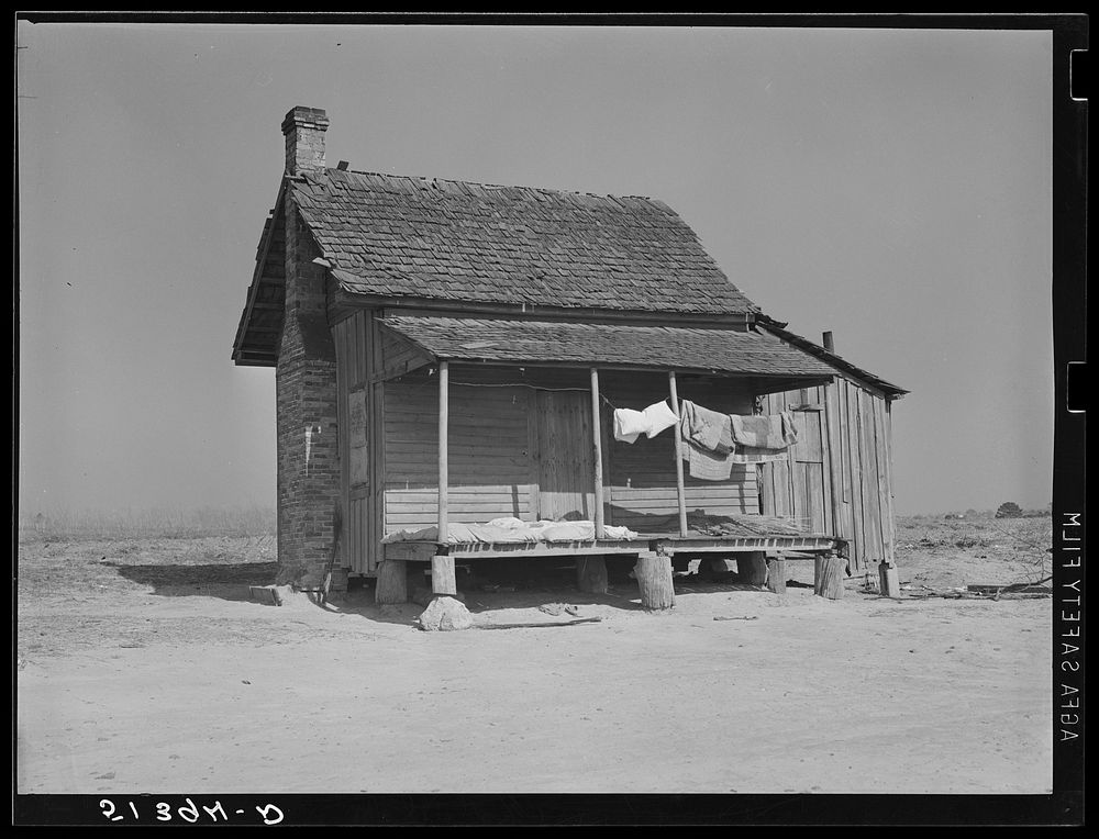 Typical old tenant's house with bedding being aired and sunned. Coffee County, Alabama. Sourced from the Library of Congress.