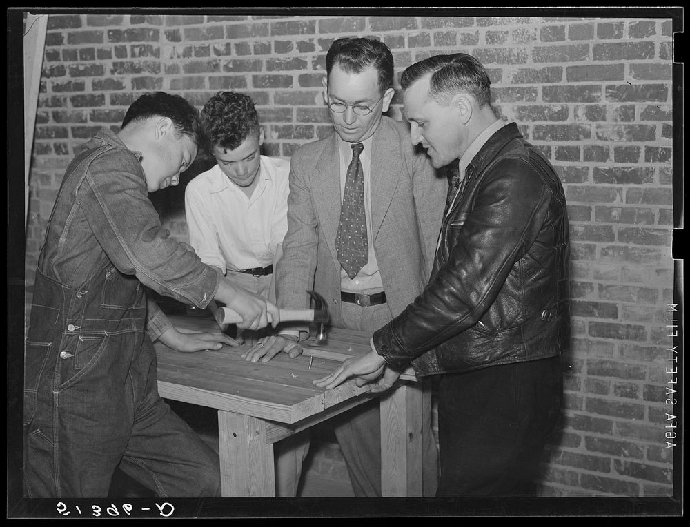 Vocational teacher and school principal help the boys make a large table in shop at Goodman School. Coffee County, Alabama.…