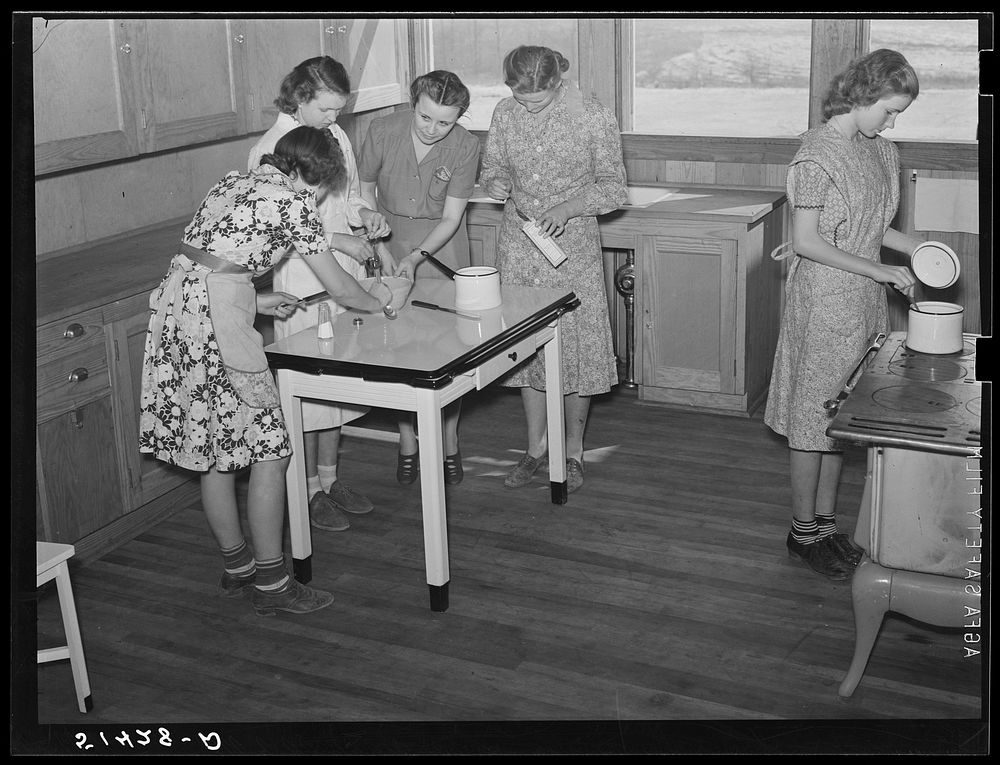 Cooking teacher and group of girls in home economics classroom. Coffee County, Alabama. Goodman School. Sourced from the…