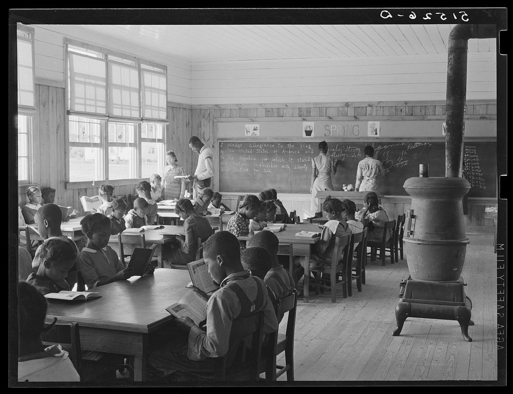 First grade, showing extremes in ages of pupils. Oldest boy standing is just learning to read. Gee's Bend, Alabama. Sourced…