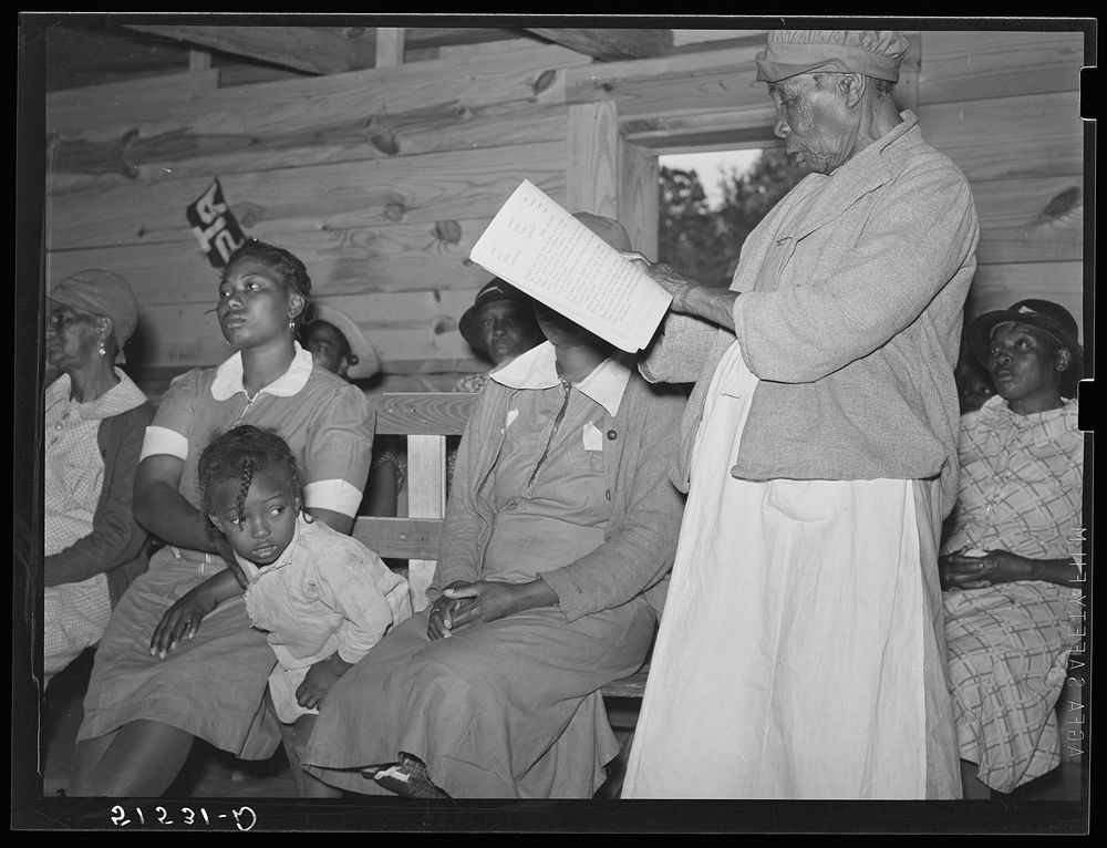 Star pupil, eighty-two years old, reading her lesson in adult class. Gee's Bend, Alabama. Sourced from the Library of…