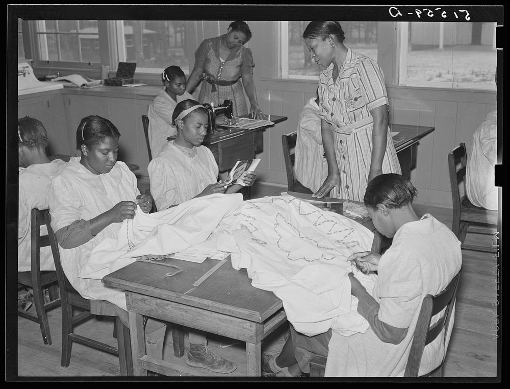 NYA (National Youth Administration) girls making bedspreads under supervision of Juanita Coleman, NYA leader, in school home…