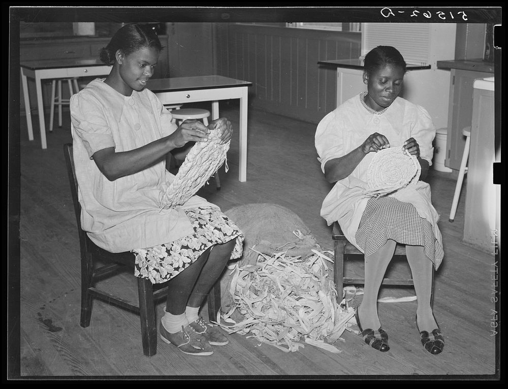 NYA (National Youth Administration) girls making mats from cornshucks in home economics room. Gee's Bend, Alabama. Sourced…