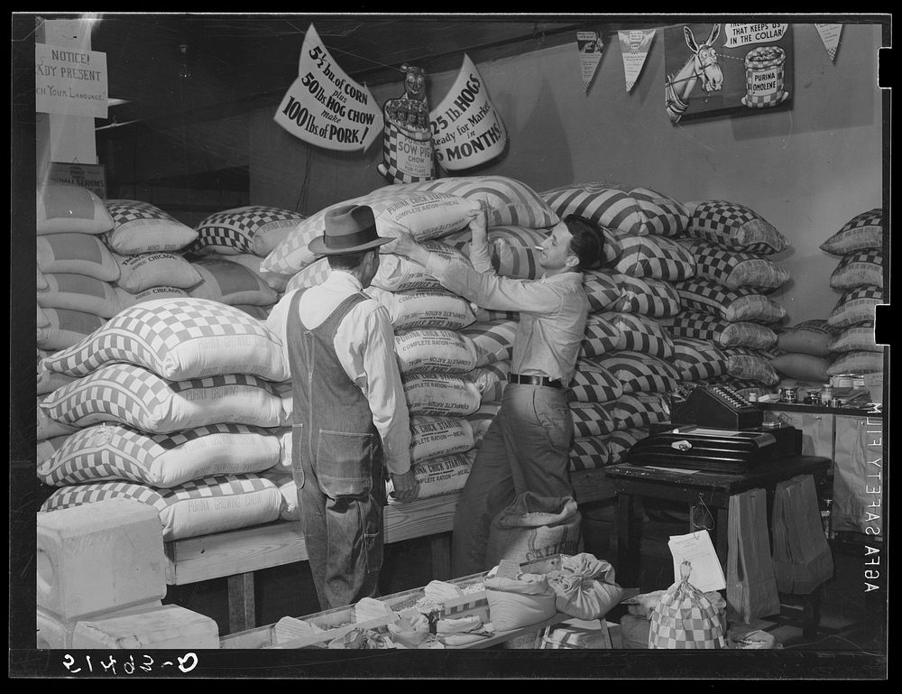 Farmer buying supplies on Saturday at farmers' exchange. Enterprise, Coffee County, Alabama. Sourced from the Library of…