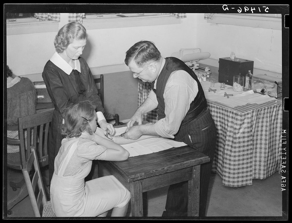 Miss Teal, nurse, and doctor W.R. Stanley giving young high school girl treatment in veneral disease clinic. Enterprise…