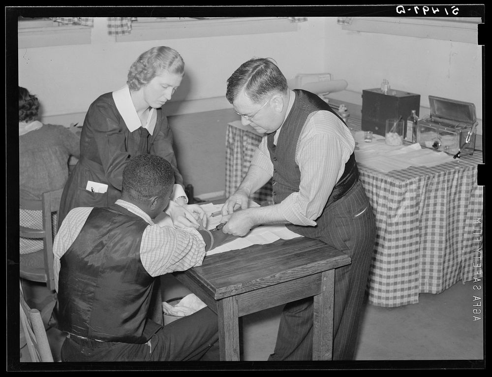 Miss Teal, nurse, and doctor W.R. Stanley giving treatment in venereal disease clinic. Enterprise, Coffee County, Alabama.…