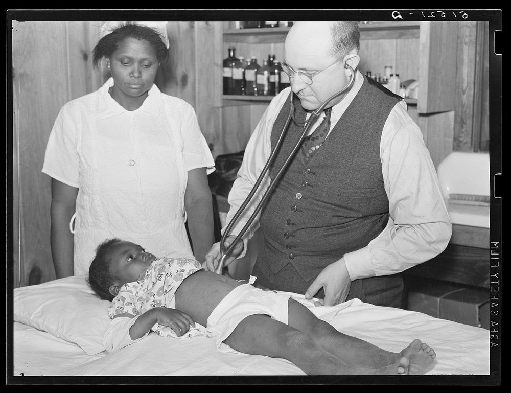 Nurse Shamburg and Dr. Dixon (R.E.) examining Susanna Pettway, whose father, Clement Pettway, has been ill for several years…