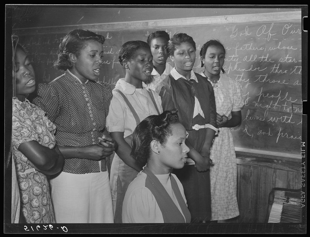 Music class practicing songs for May Day-Health Day festivities. Flint River Farms, Georgia. Sourced from the Library of…