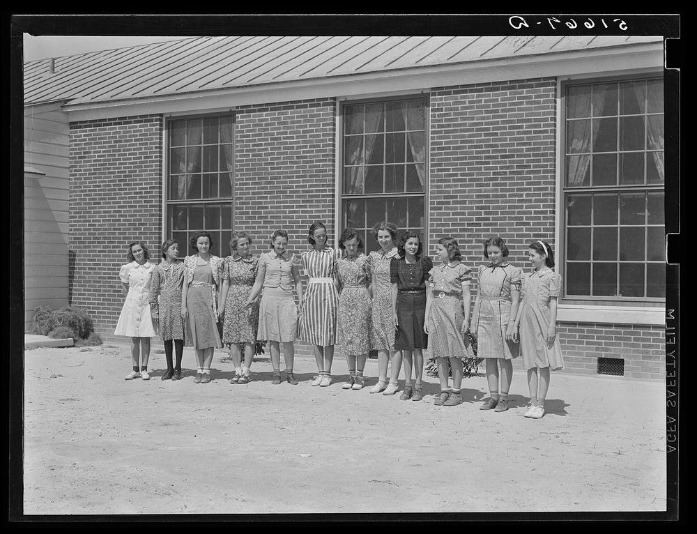 Students wearing dresses they made in home economics class in school at Ashwood Plantations, South Carolina. Sourced from…
