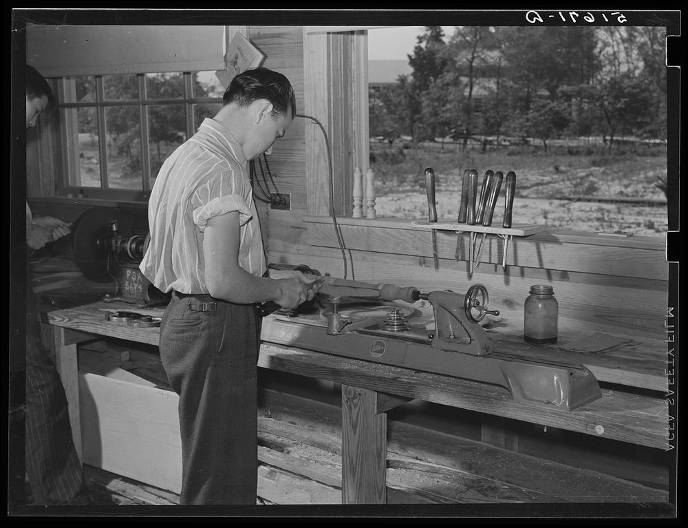 Clarence Haseldon turning lathe to make table leg in shop class. Ashwood Plantations school, South Carolina. Sourced from…