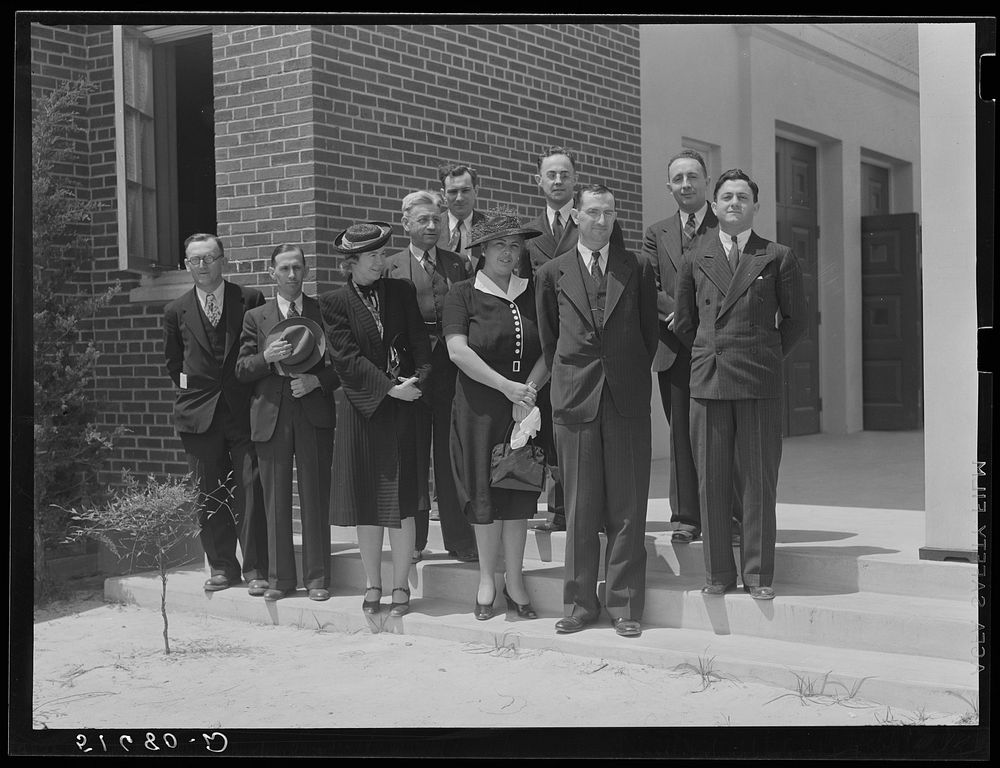 Group of speakers and guests with project manager Mr. Cathcart (at extreme left) on steps of auditorium after May Day-Health…